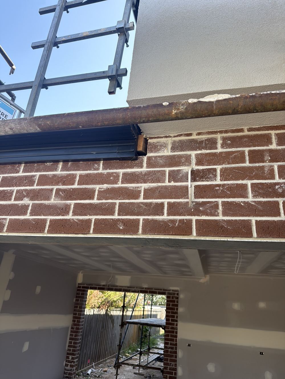 Timber frame left exposed between the brickwork and the fascia, found during a fixing inspection in Berwick