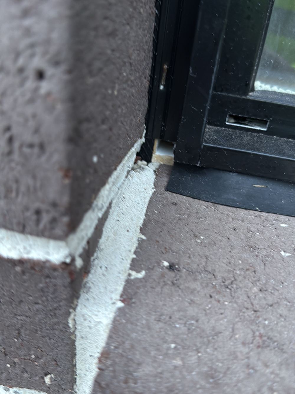Kitchen window fitted without flashing, visible where infill was missing, found during a fixing inspection in Berwick