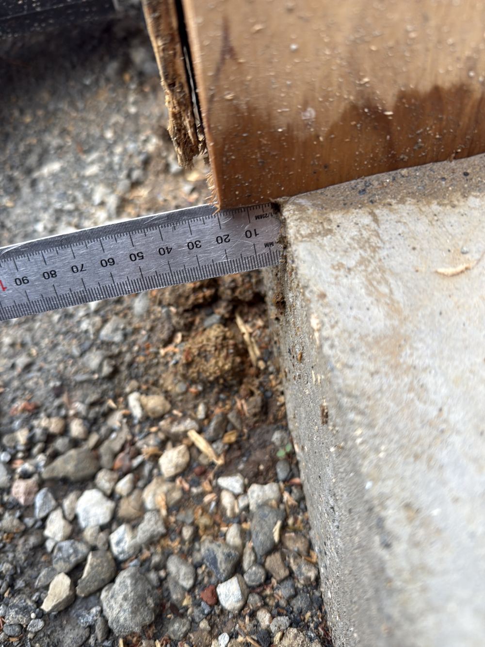 Bottom plate hanging past the slab edge by more than the allowed tolerance, found during a frame inspection in Berwick
