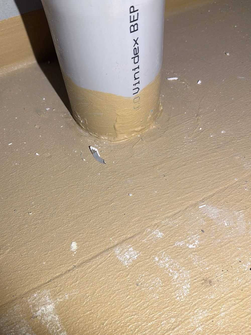 Waste pipe through the membrane with no bandage or bond breaker, found during a waterproofing inspection in Berwick
